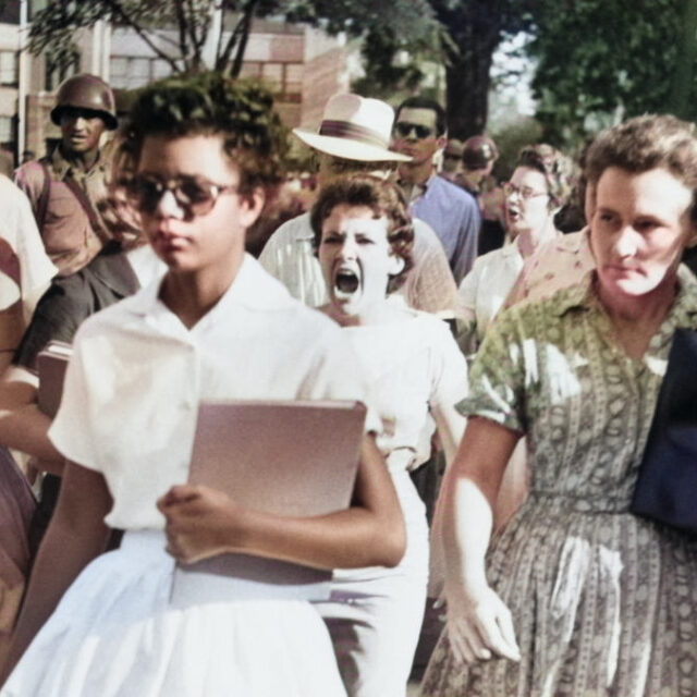 Colorized photo of Elizabeth Eckford, one of the Little Rock Nine, walking alone through a hostile mob during the desegregation of Central High School in 1957.