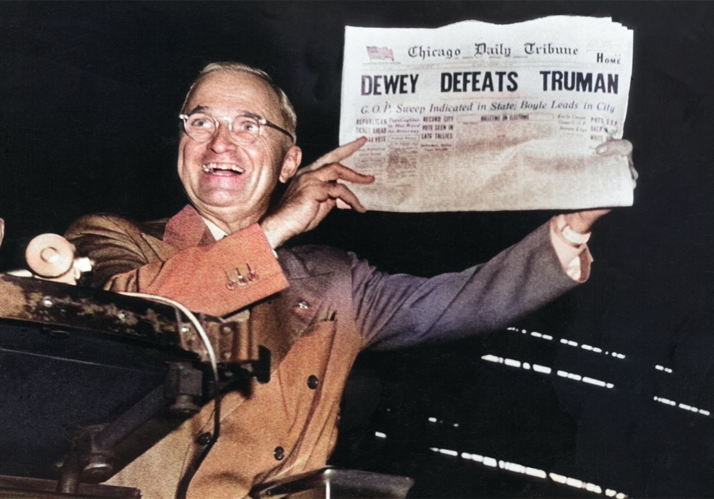 President Harry Truman smiling and holding up the Chicago Daily Tribune newspaper with the incorrect headline "DEWEY DEFEATS TRUMAN.
